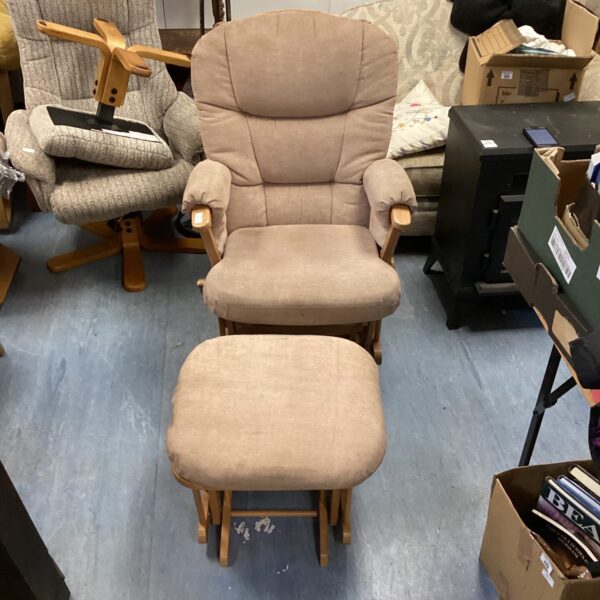 Beige upholstered rocking armchair with footstool, vintage style.