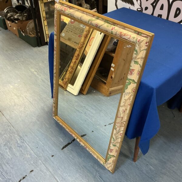 Vintage bevel edge mirror with ornate frame for home decor.