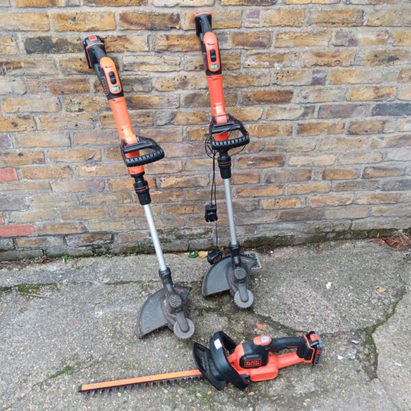 Black & Decker cordless garden tools set including grass trimmer and hedge cutter.