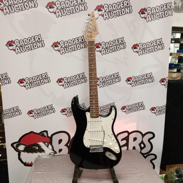 Black Fender Squire Stratocaster electric guitar with new strings.