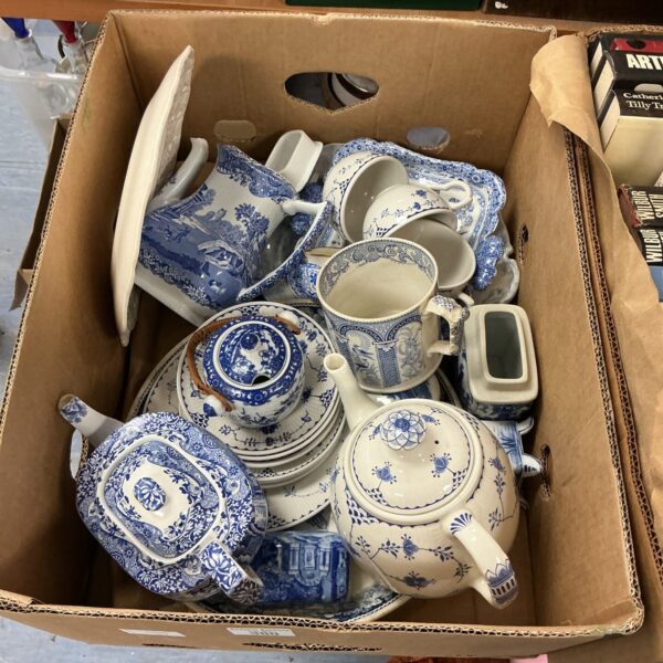 Vintage blue and white china collection with teacups and serving dishes.