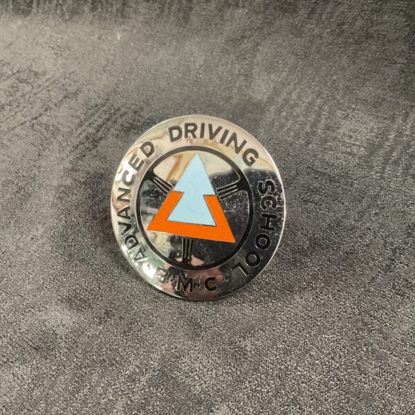 Vintage BMC Advanced Driving School badge on a white background.