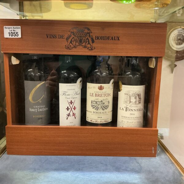 Four bottles of Bordeaux wine in a decorative presentation box.
