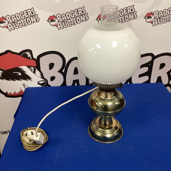 Vintage brass oil lamp repurposed as a functional table lamp.