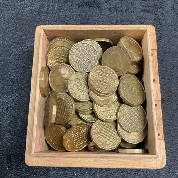 Lot of vintage brass threepenny coins for collectors.