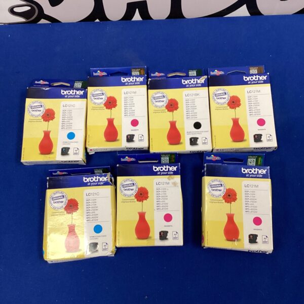 New Brother LC121 ink cartridges in cyan, magenta, and black, sealed in packaging.