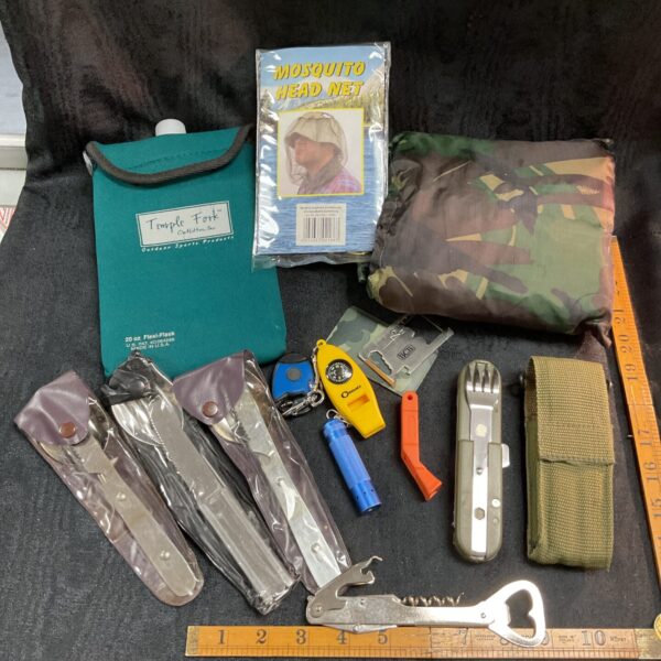 Vintage camping equipment lot with poncho, cutlery, and mosquito net.