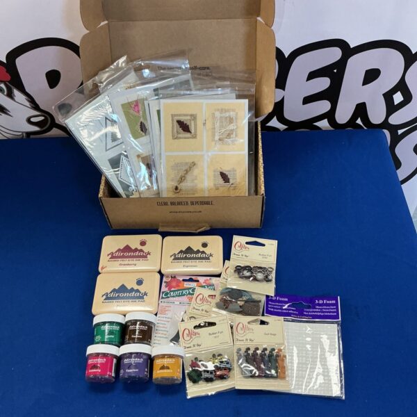 New card crafting supplies lot with embossing powder and ink pads.