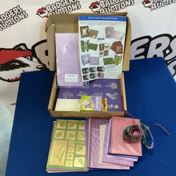 Card making craft lot with floral embossed paper and ribbons.