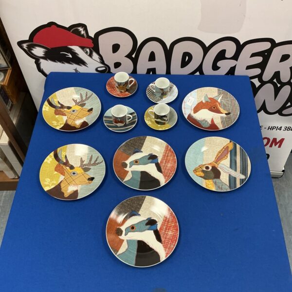 Vintage Carola Van Dyke plates with floral designs and coffee cups.