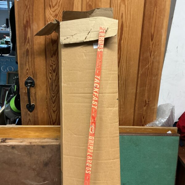 Box of used carpet gripper for flooring projects.