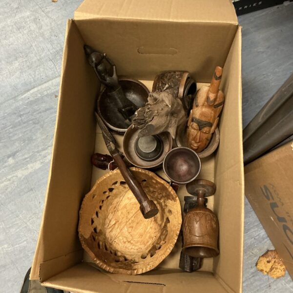 Vintage carved wooden fruit bowl and decorative items on display.
