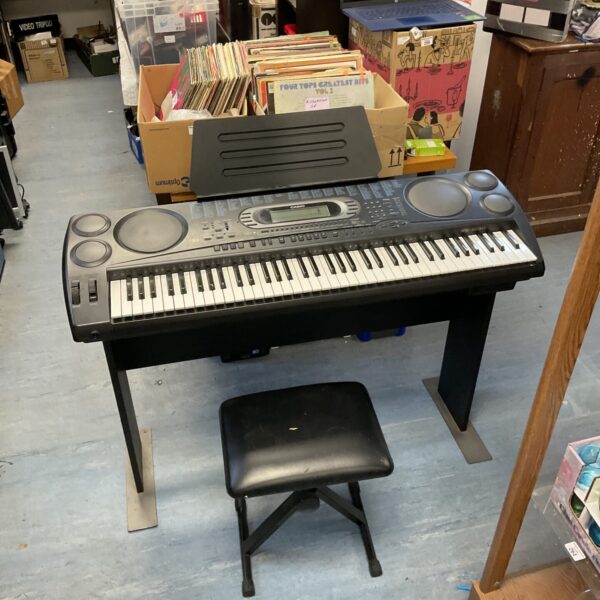Used Casio WK-1800 keyboard with stool and stand for music practice.
