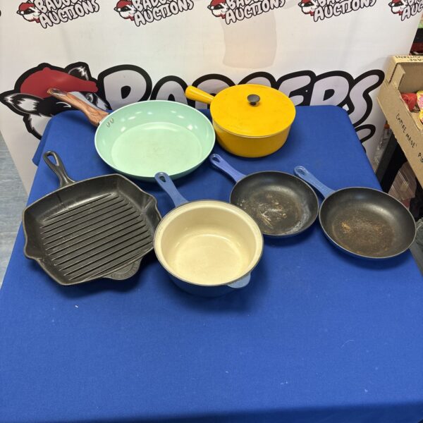 Selection of vintage cast iron cookware including Le Creuset.