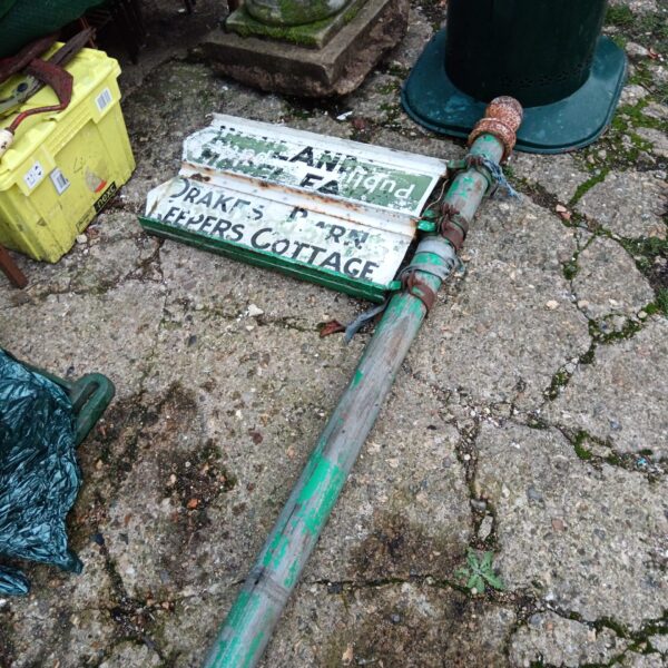 Vintage cast iron directional sign post with enamel signage.
