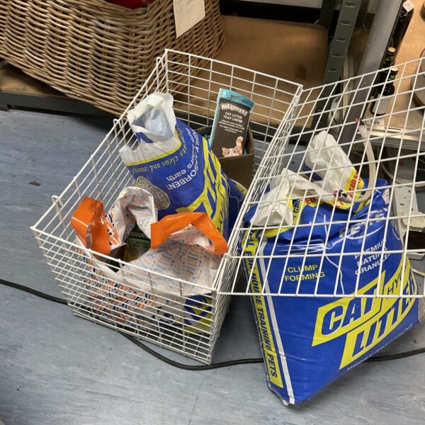 Cat supplies lot including litter, liners, and cage.