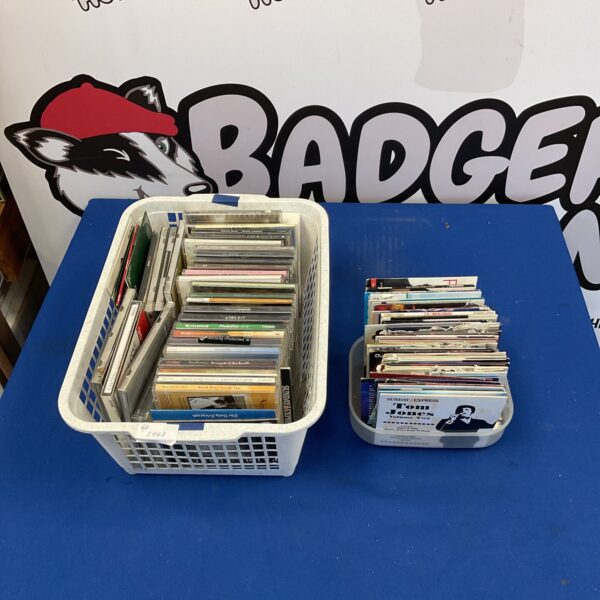 Basket of assorted CDs including Adele, Cliff Richard, and Robbie Williams.