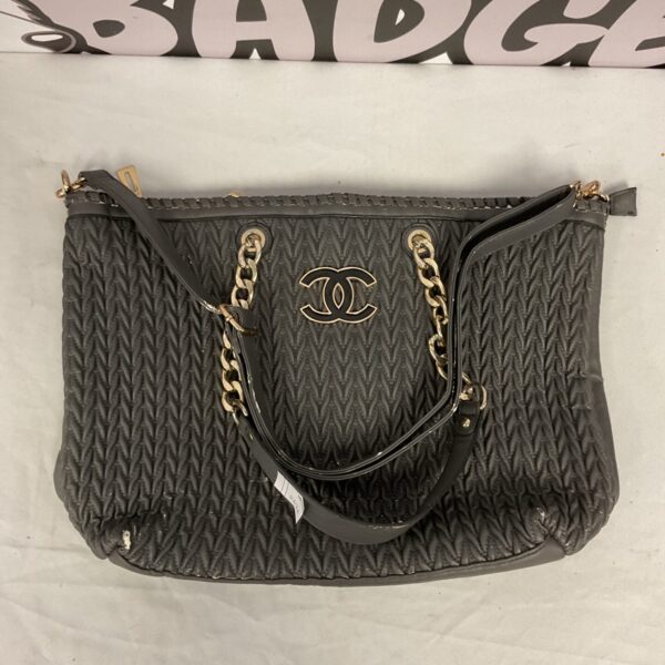 Black quilted Chanel style handbag with chain handle.