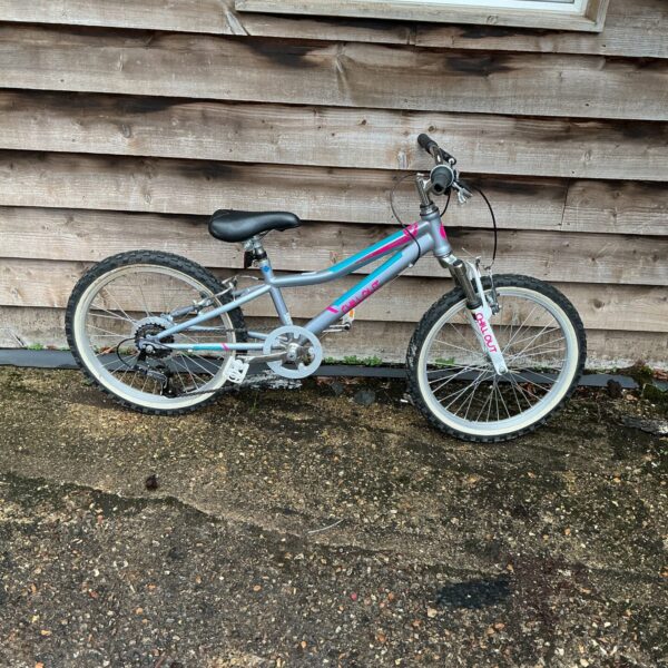 Grey and white child’s bike with front suspension for sale.