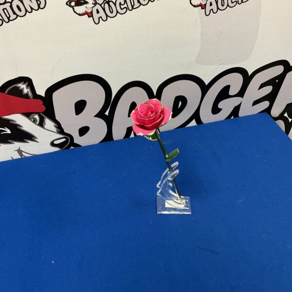 Delicate porcelain China Rose displayed on a decorative stand.