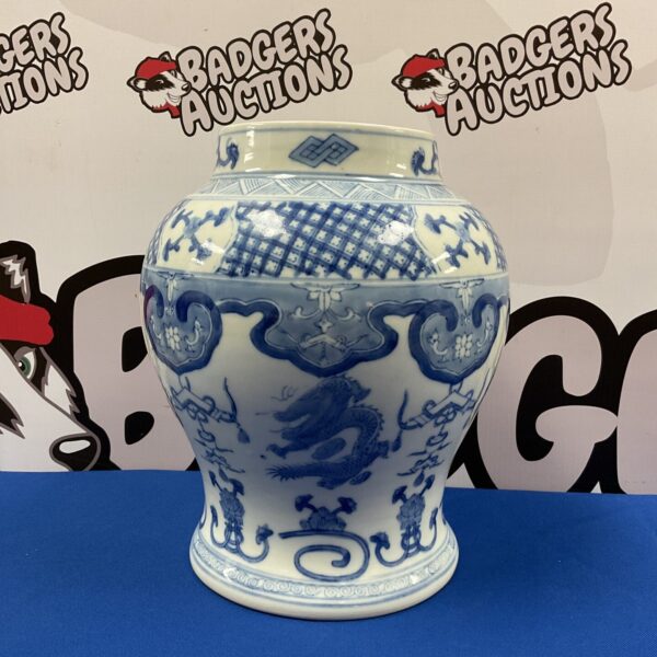 Antique Chinese blue and white dragon vase with intricate details.