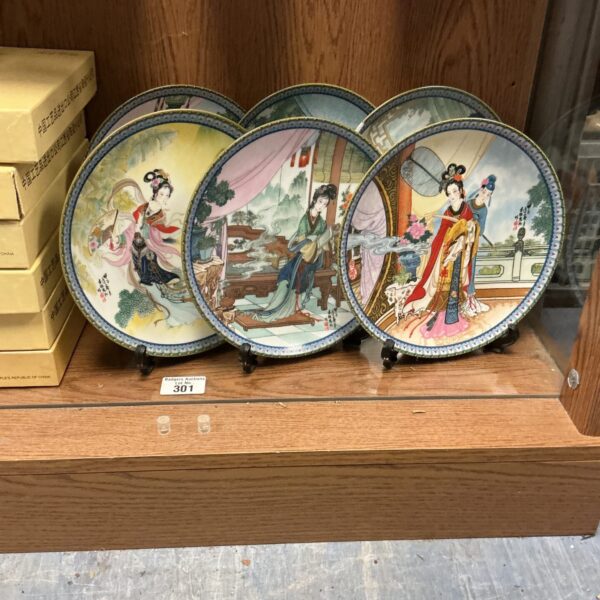 Set of six vintage Chinese porcelain plates with detailed designs.