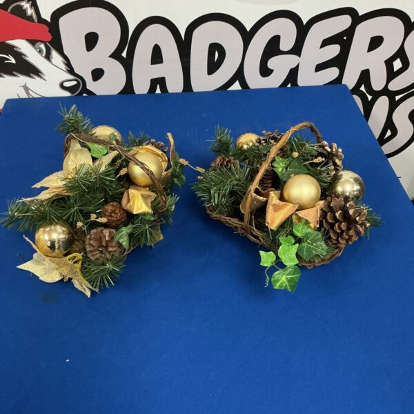 Festive Christmas basket arrangement with pinecones and berries.