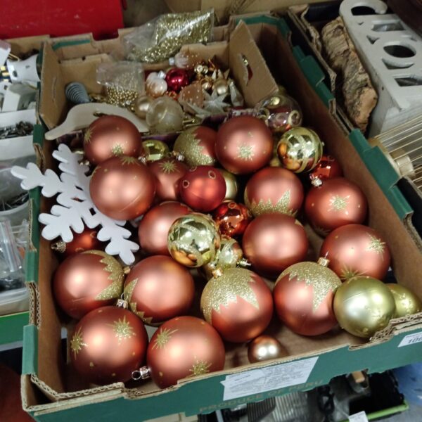 Vintage red and gold Christmas baubles in a tray.