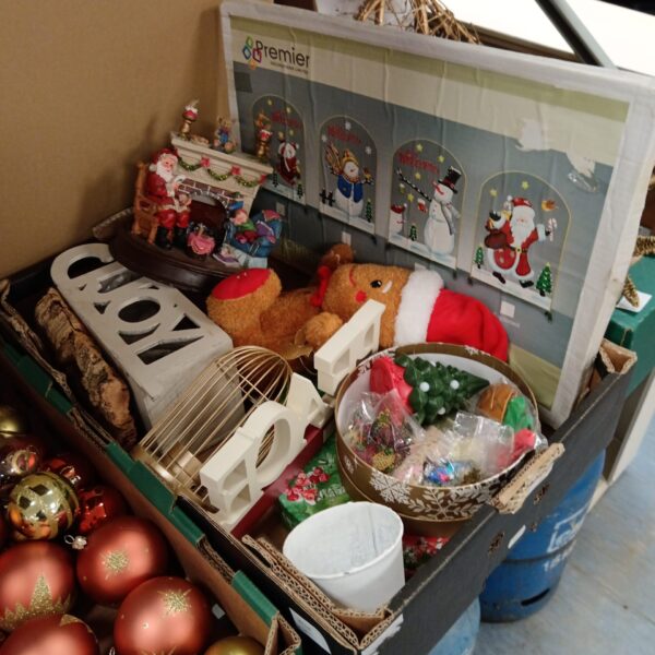 Assorted Christmas decorations including a resin Santa fireplace ornament.