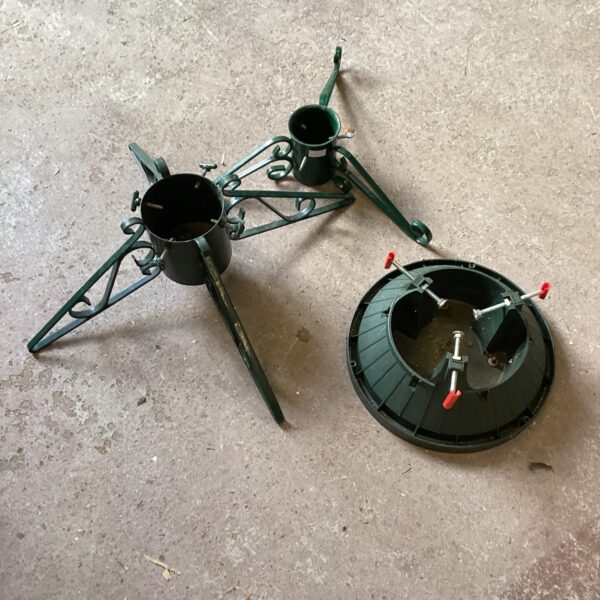 Metal Christmas tree stand with three legs for stability.