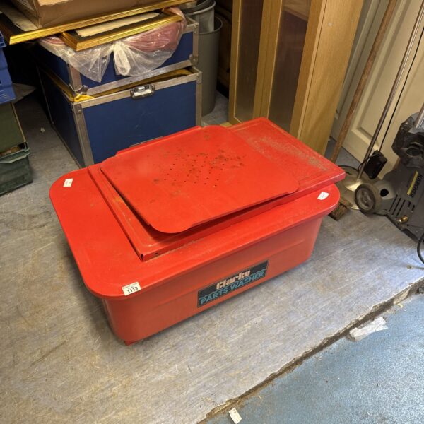 Red Clarke parts washer tank with legs inside.