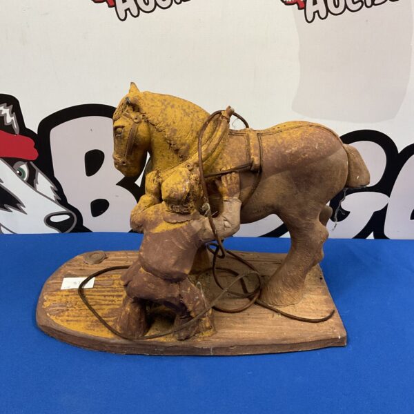 Detailed clay pottery sculpture of a horse and farrier.