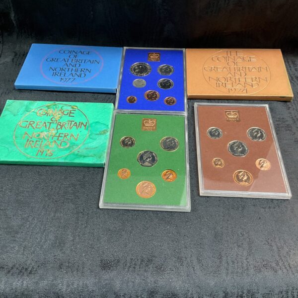 Coinage of Great Britain proof sets from 1974, 1975, and 1977, collectible coins.