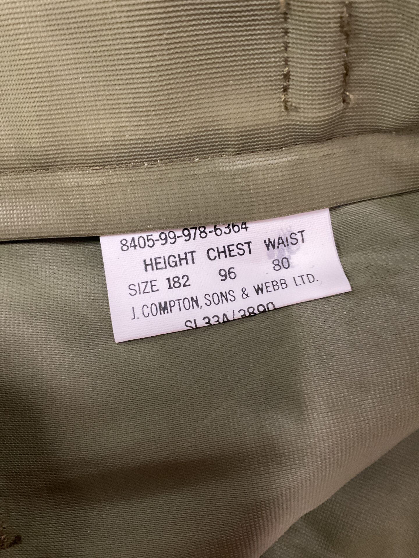 Close-up of the trousers' label with size and details.