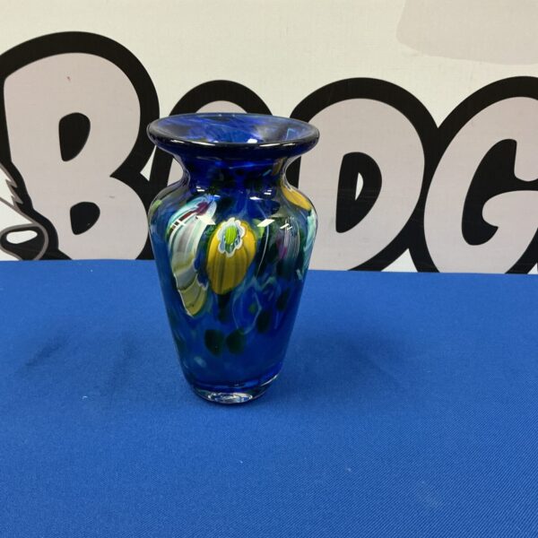 Vibrant colourful Murano glass vase with swirling colours.