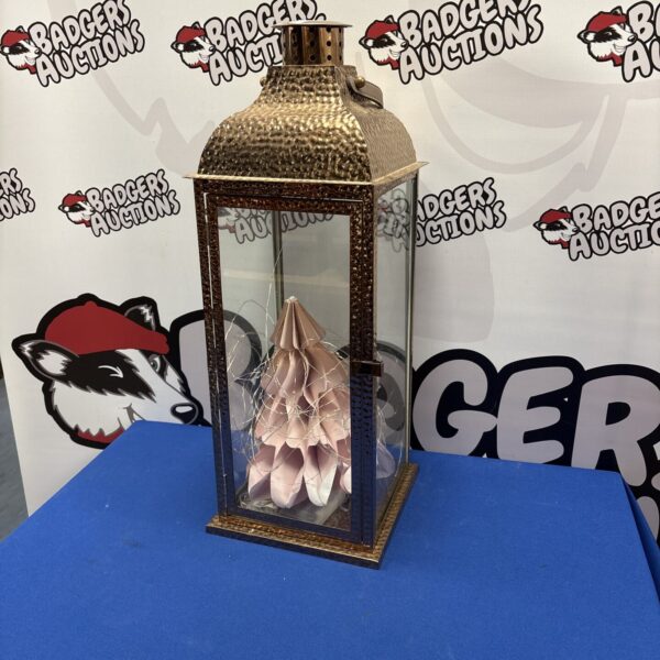 Close-up of a copper effect decorative lantern with intricate metalwork.