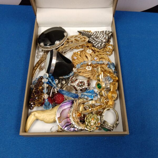 Vintage costume jewellery brooch lot with floral and geometric designs.