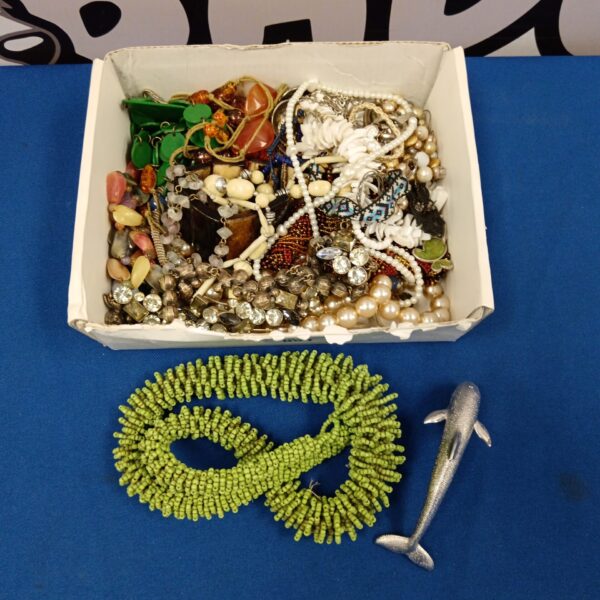 Costume jewellery lot with necklaces and bracelets on display.