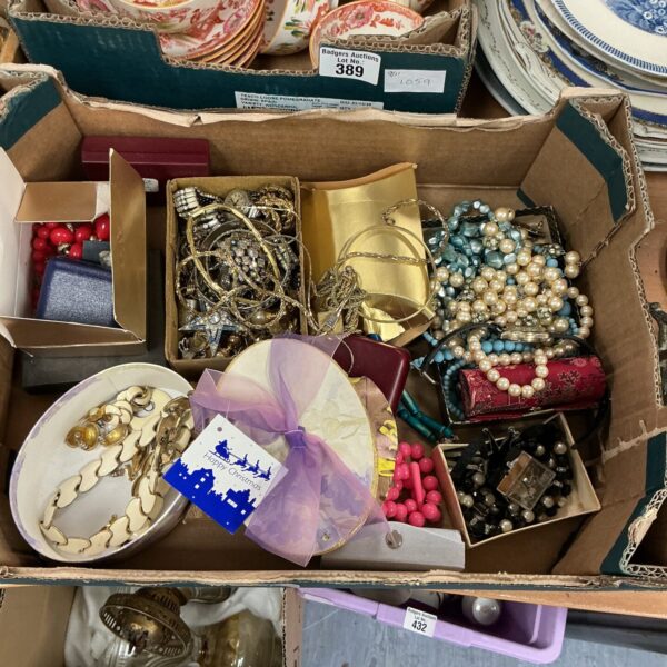 Tray of colourful costume jewellery with necklaces, brooches and earrings.