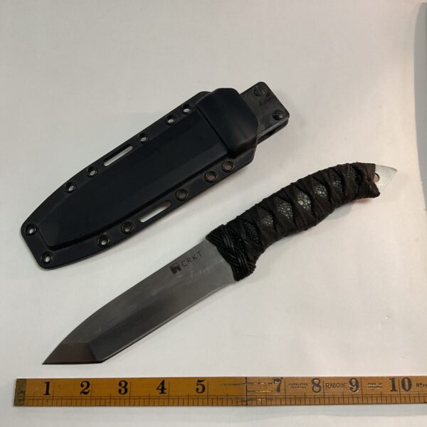 Black bladed CRKT sheath knife with nylon sheath.