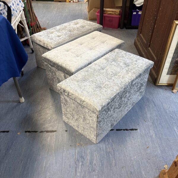 Set of three crushed velvet collapsible ottomans for storage and seating.