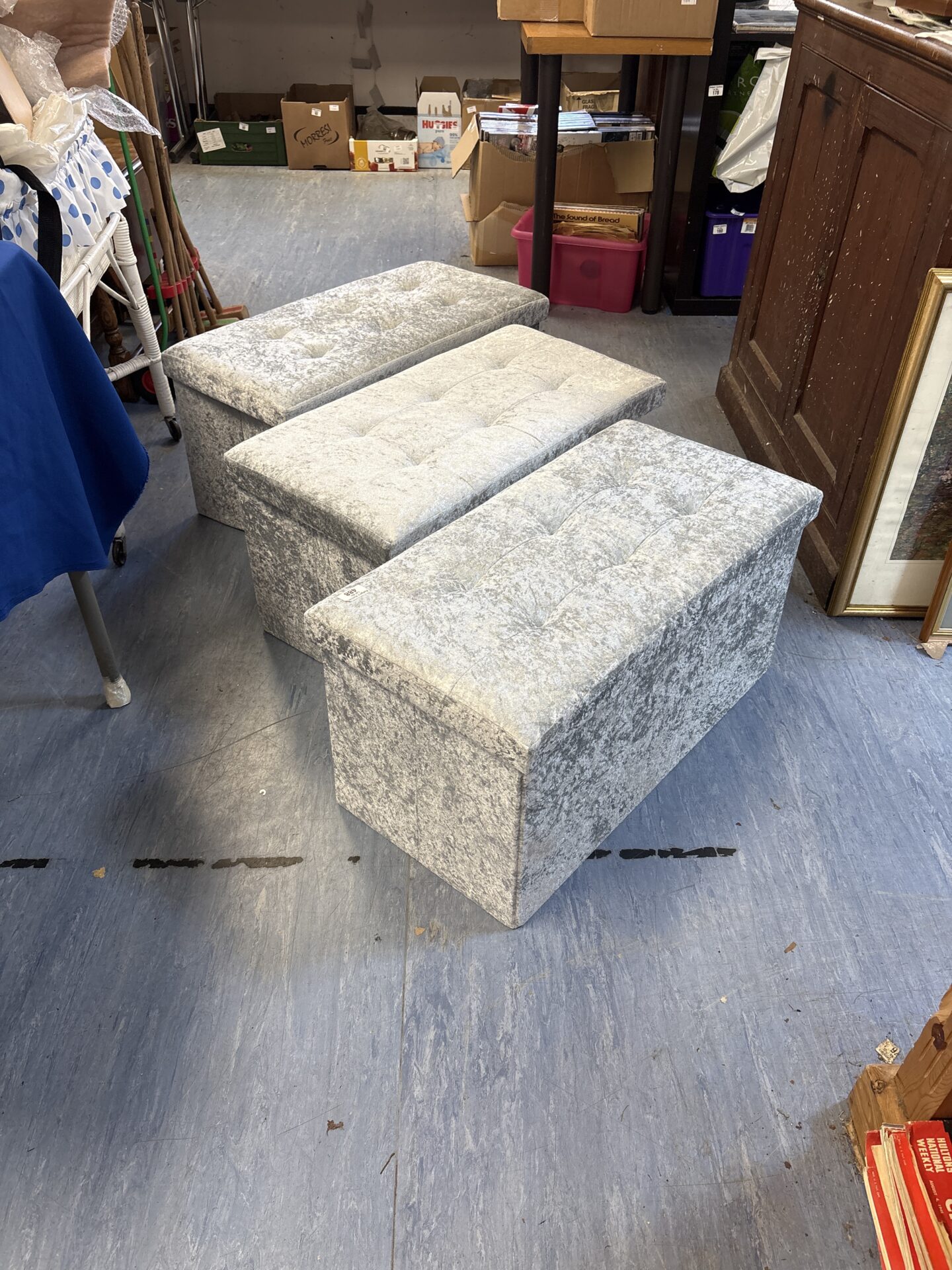 Set of three crushed velvet collapsible ottomans for storage and seating.