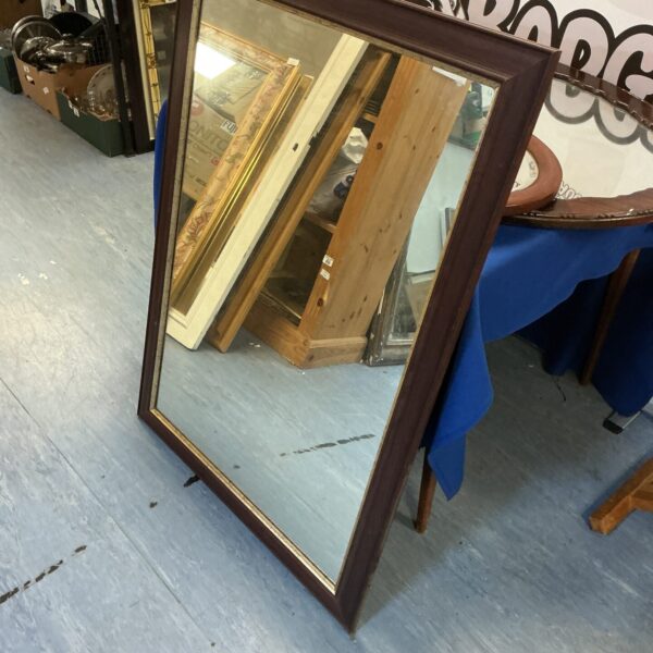 Vintage dark wood framed mirror for home decor.