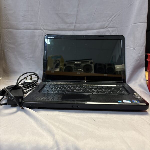 Dell Inspiron N5030 laptop with power supply, side view.