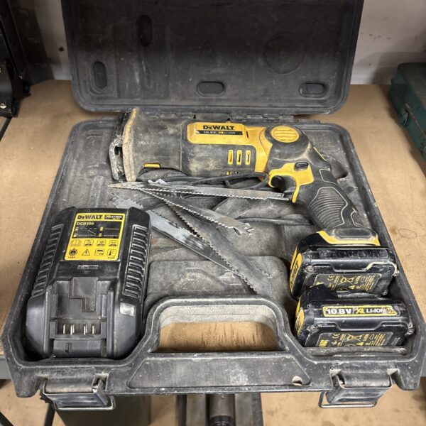 DeWalt reciprocating saw in a hard case, showing signs of use.