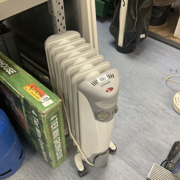 White Dimplex oil filled radiator with castors for easy movement.