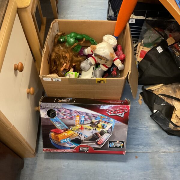 Mixed toy lot featuring a Disney Cars playset and other figures.
