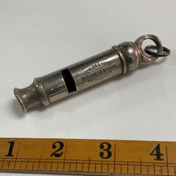 Vintage Dowler police whistle with chain, brass antique collectible.
