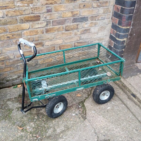 Draper metal trolley with pneumatic tyres in a garden setting.