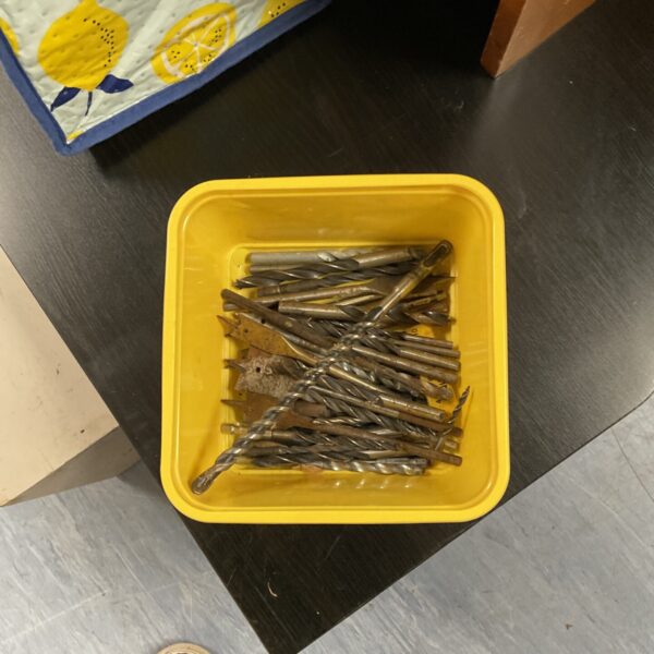 Assorted drill bit set in a plastic container.